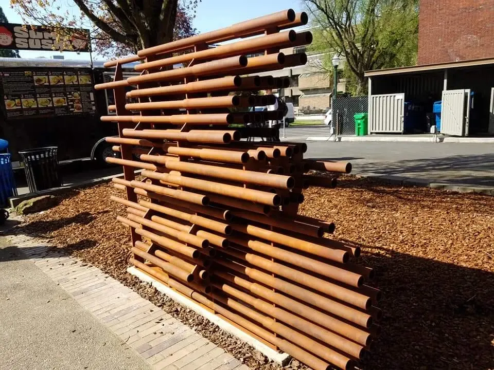 Oblique view of Anthropocene showing the staggered lengths and two diameters of steel pipe.