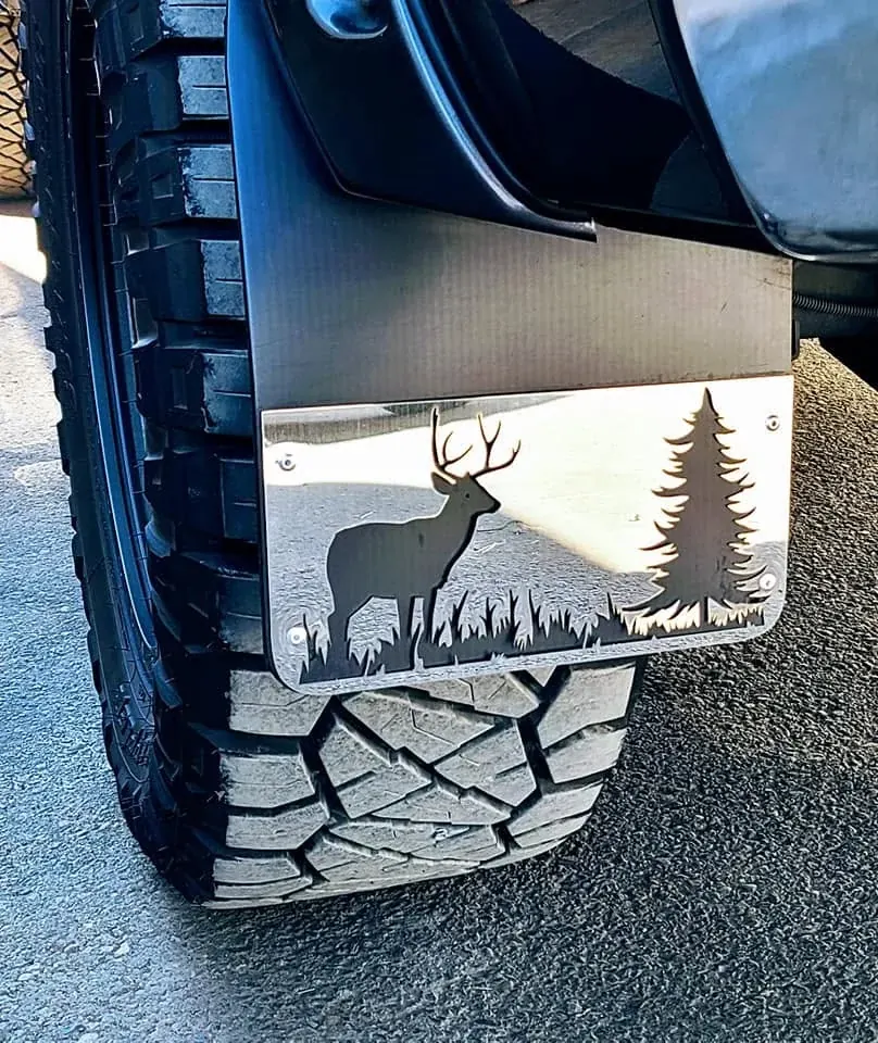 An elk and trees on a mudflap panel.