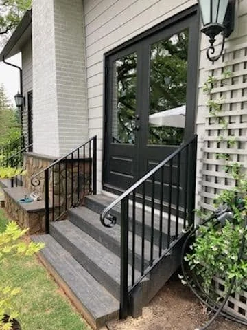 The railings beside the entrance steps.