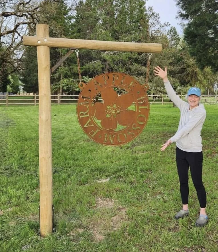 The garden sign hanging from its timber frame.