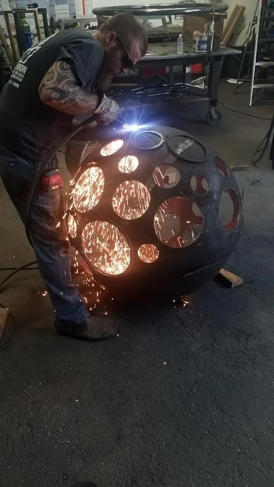 Welding the curved shell of the fire sphere.