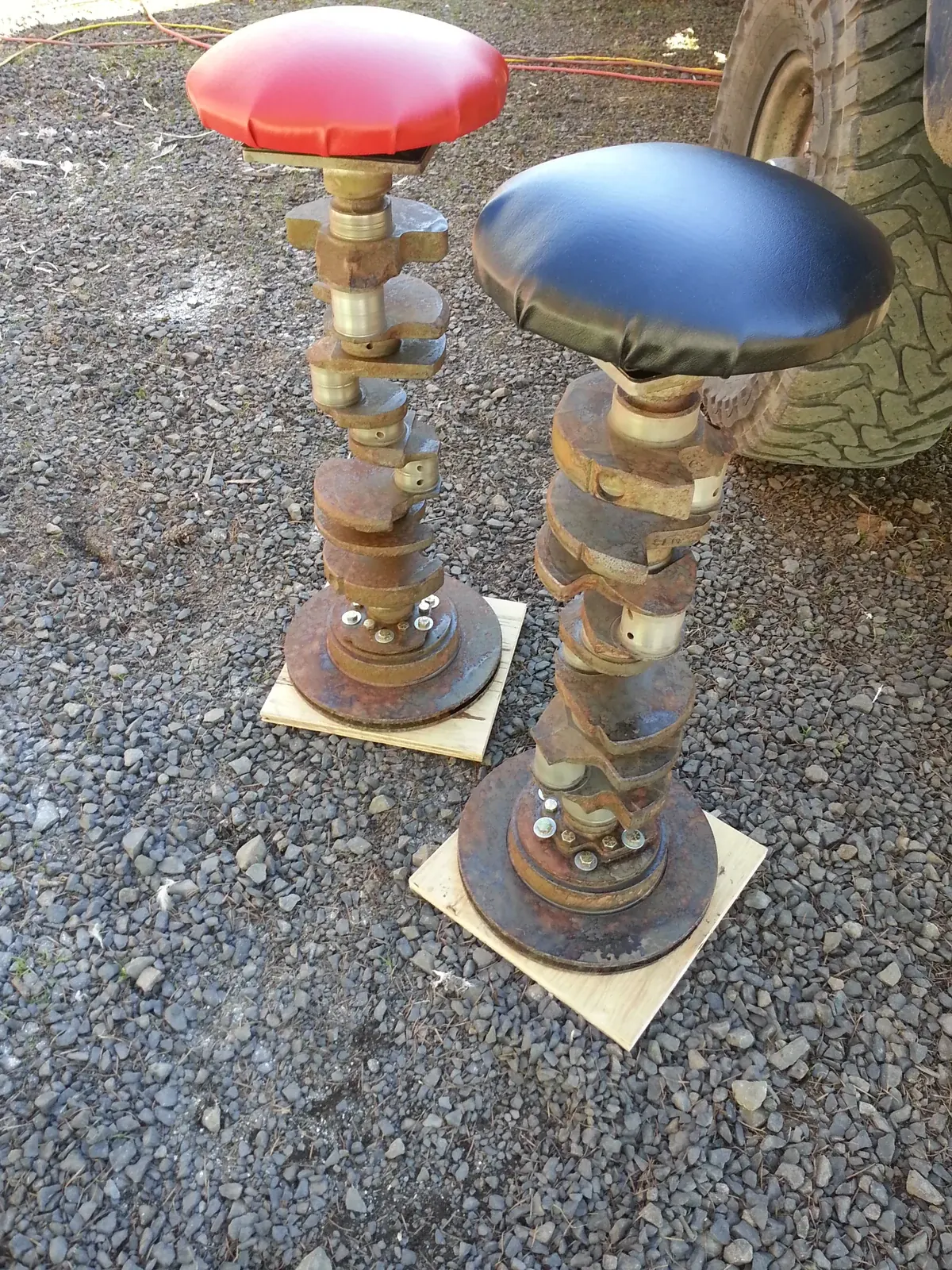 Two completed stools with red and blue seats.