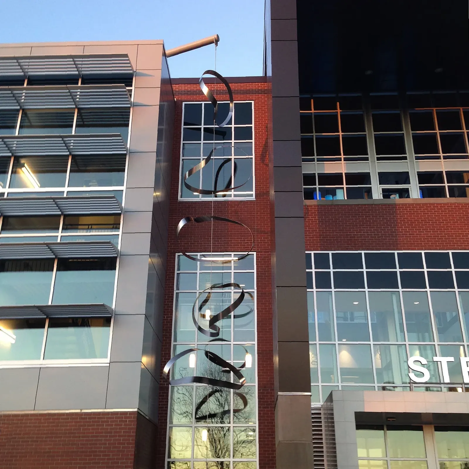 Five steel Möbius rings suspended outside the STEM Building at Clark College.
