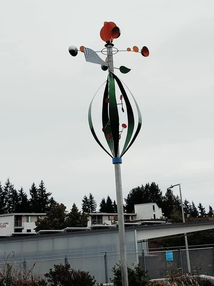 Photosynthesis Whirligig on its tall stainless steel support at Hazel Wolf K–8 STEM School.
