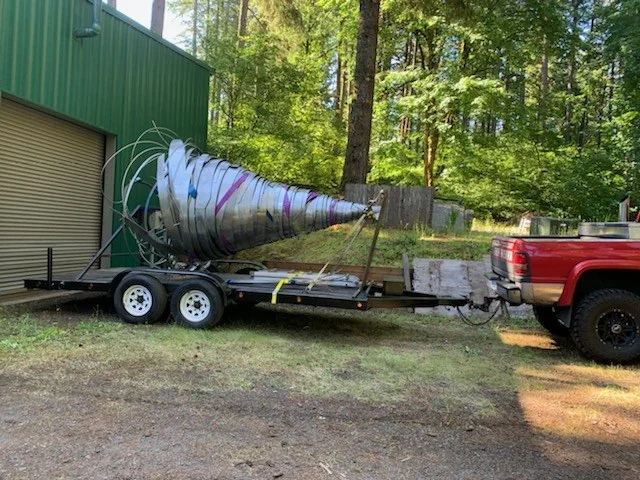 The sculpture secured on the trailer outside the shop.