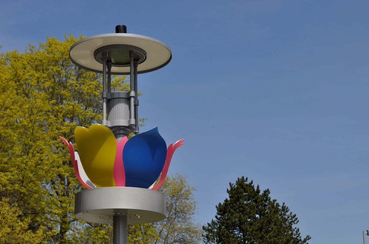 Hybrid Flowers on a Redmond lamp post, with yellow, blue and pink resin petals above the aluminum lighting base.