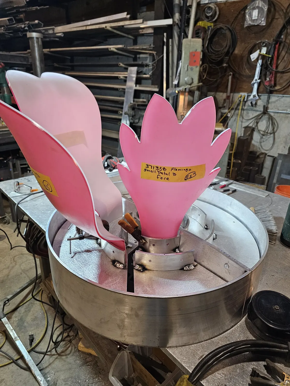 Pink resin flower petals fitted to the aluminum housing on the shop bench.