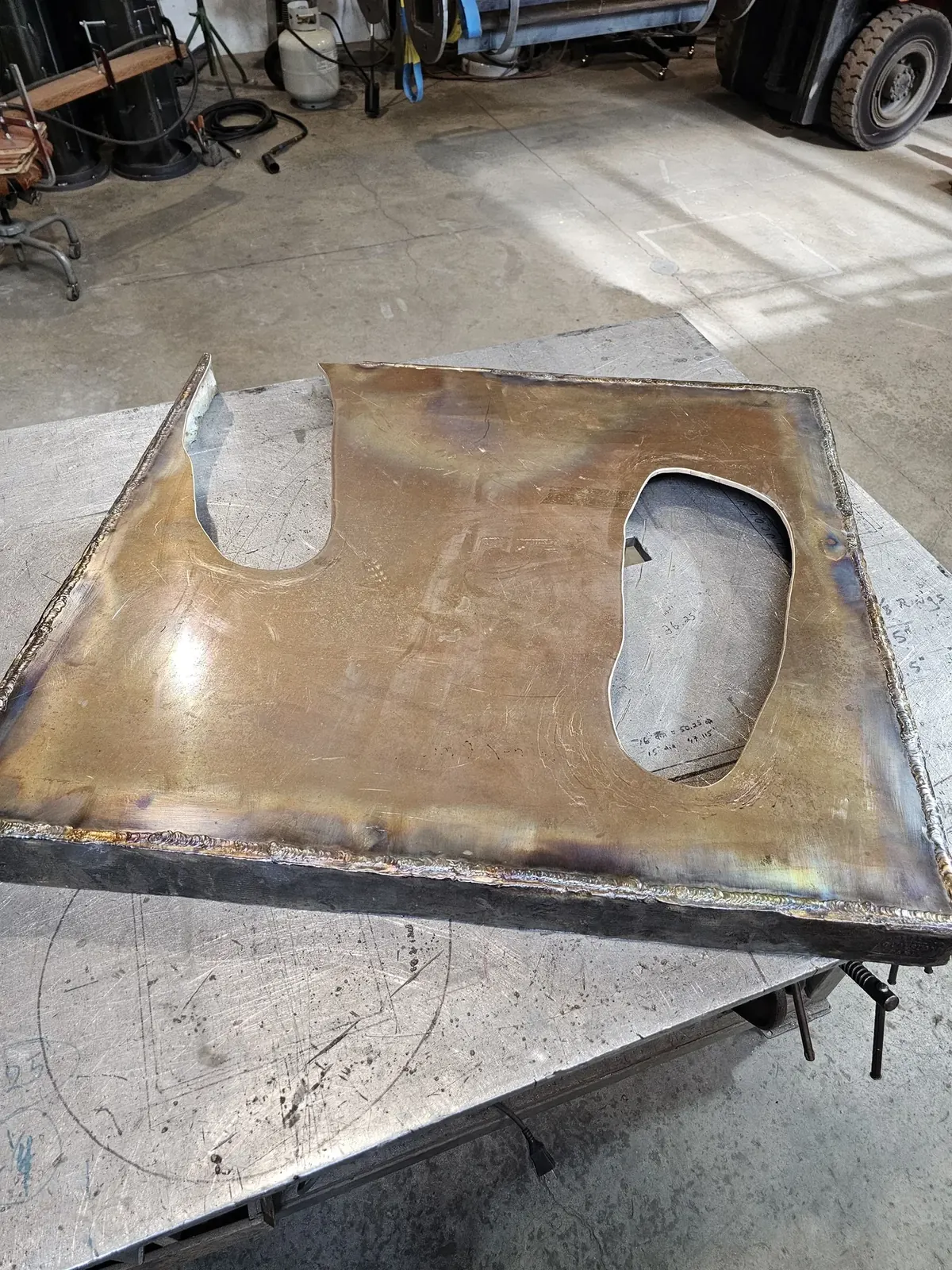 Replacement base on a workbench with two shaped openings for the original statue feet.