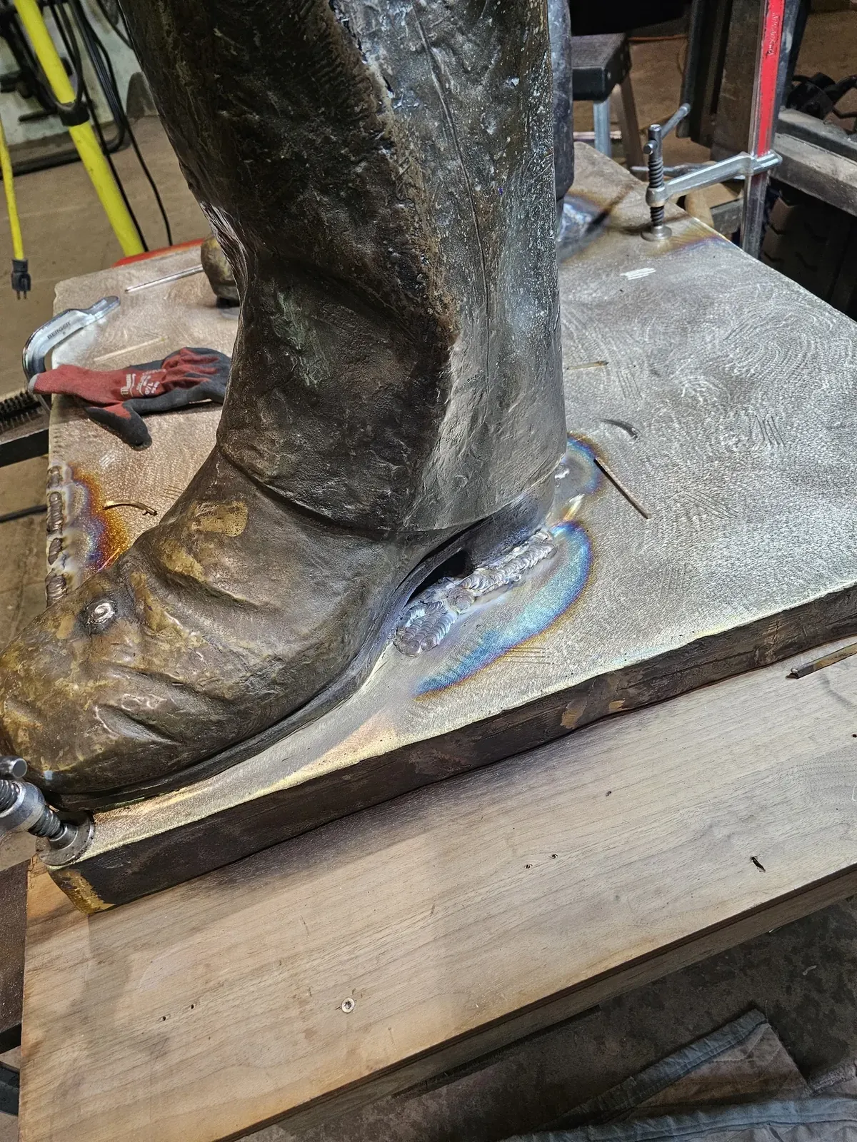 Close view of a bronze shoe and its welded connection to the new plate, before final surface finishing.