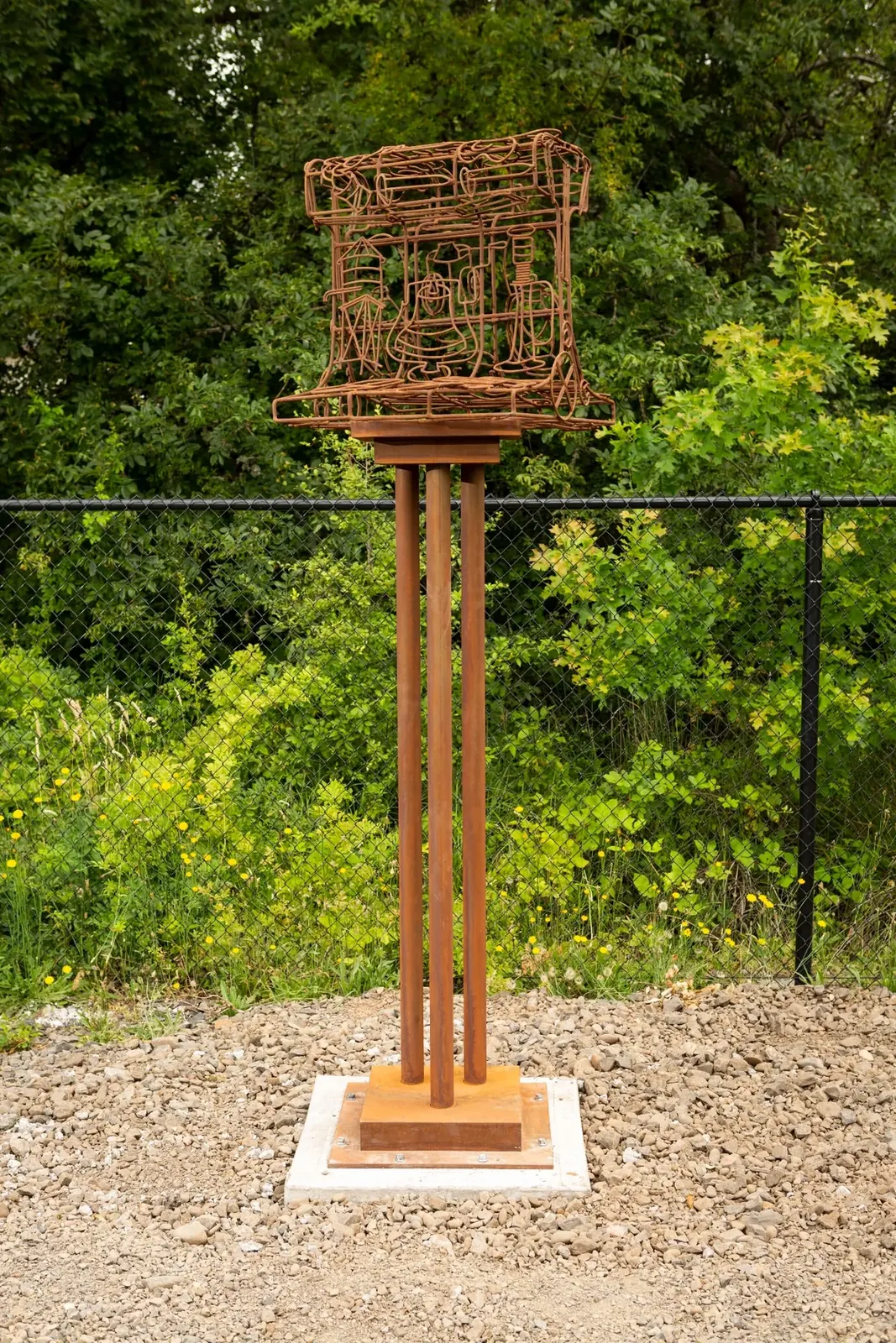 Advance, an oversized open steel railroad-track section on a tall pedestal at the Outdoor Museum in Tigard.