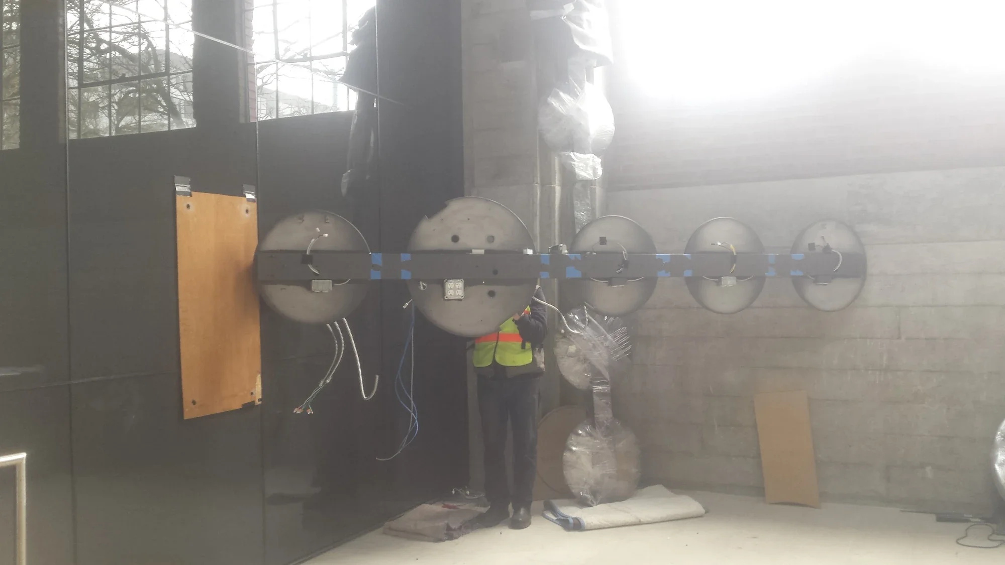 The horizontal arm of Mechanism supported on temporary timber posts with its circular housings exposed during installation.