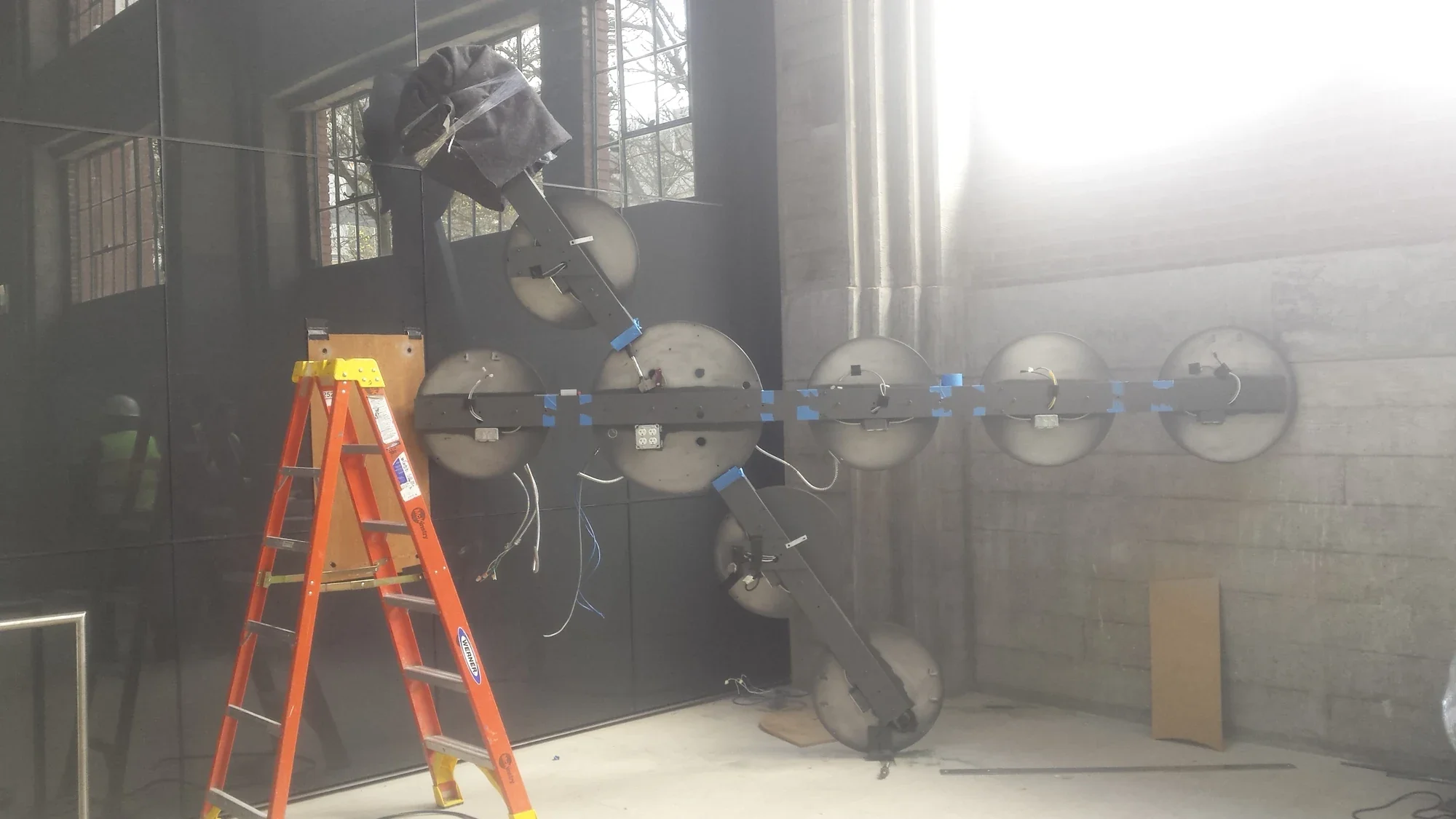 Both intersecting arms assembled at Troy Block, with an orange ladder beside the open circular housings.