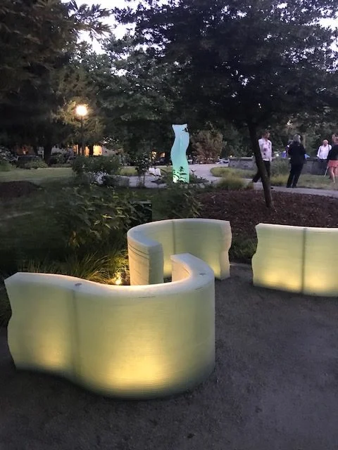 Reverie illuminated beside the park path at dusk.