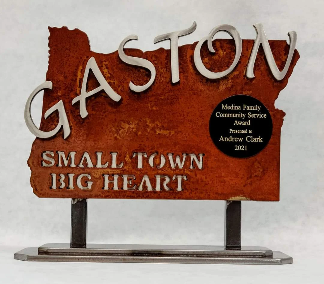 Tabletop Gaston community award with raised lettering on an Oregon-shaped metal panel and a freestanding base
