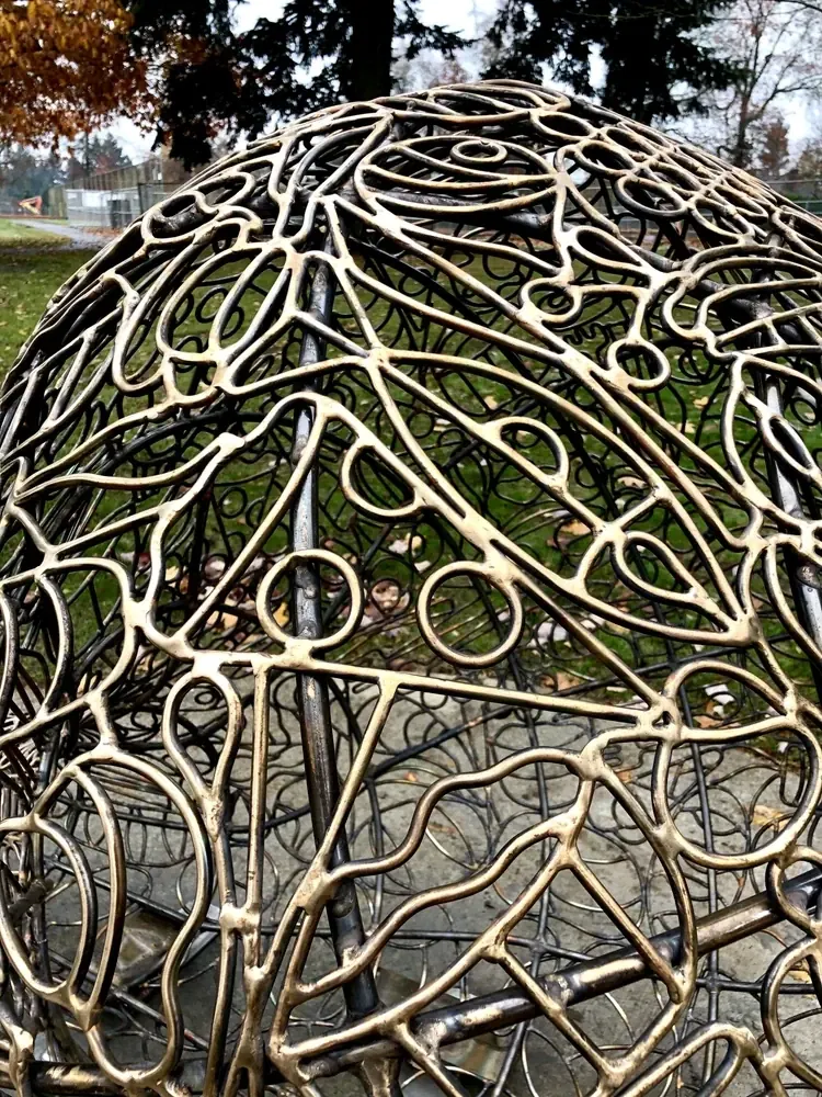 Bronze outlines of pizza slices, ice cream cones and other foods across the curved Food sculpture.