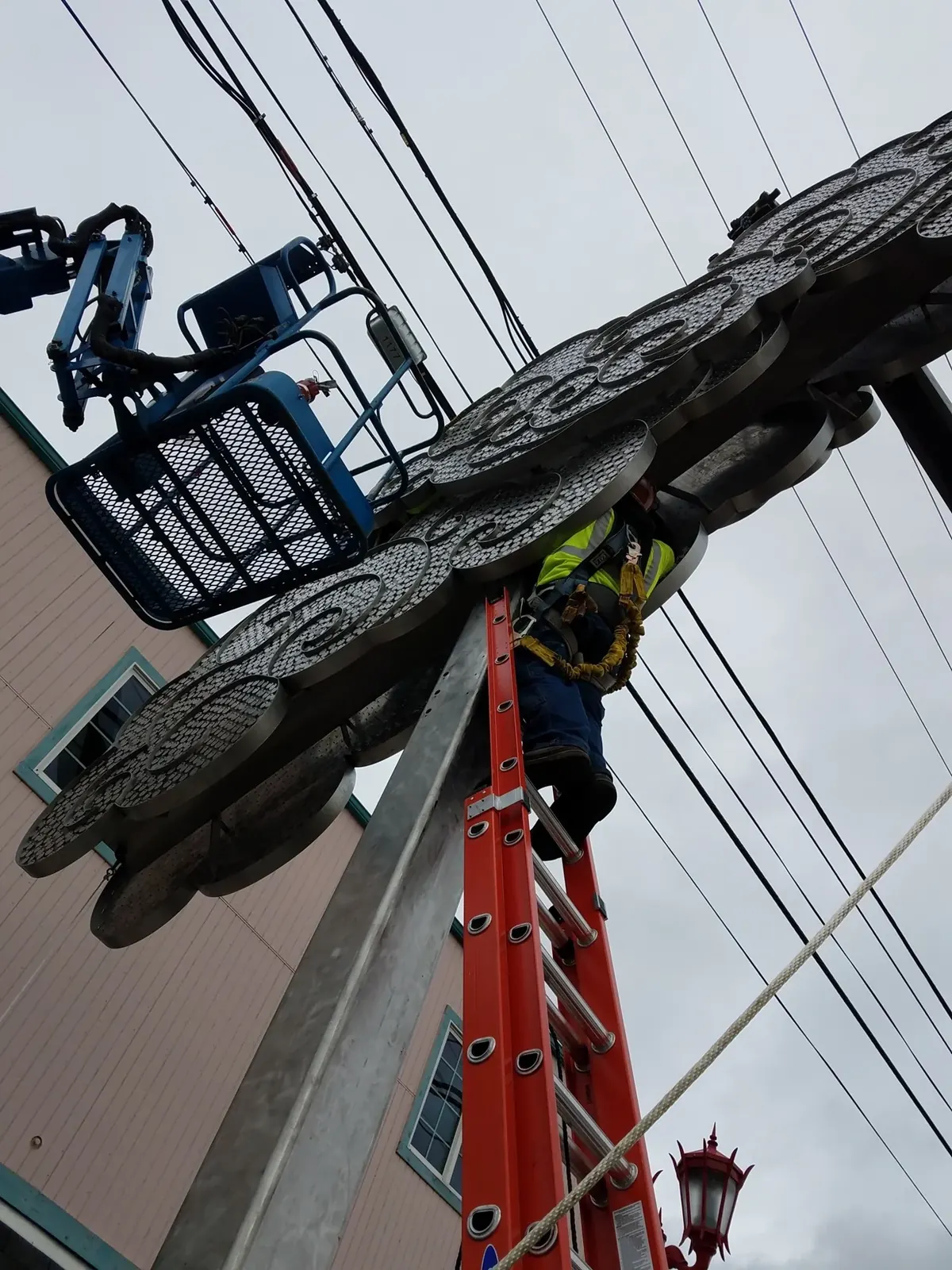 The cloud assembly being installed above the sidewalk.