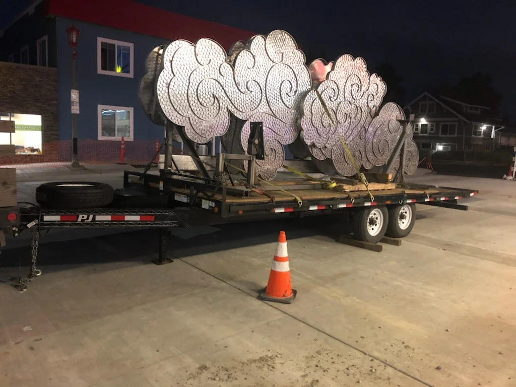 Unwrapped cloud forms on the trailer before the lift.