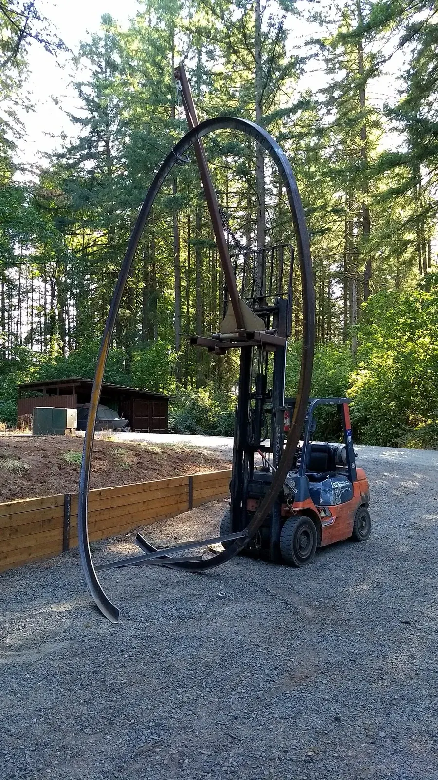 The large loop held upright beside the forklift.